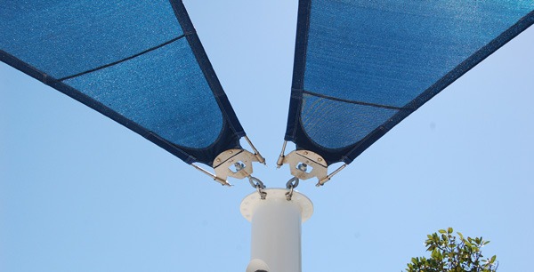 Attachment points of canopy to supporting pole on shade structure.