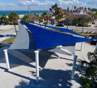 a big blue shade structure covering a parking ot