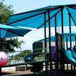 light blue shade structure covering kid's playground